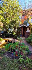 a garden with flowers in front of a house at Mountain Haven Kaapsehoop in Kaapsehoop