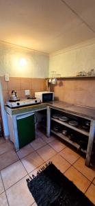 a kitchen with a table and a microwave in it at Mountain Haven Kaapsehoop in Kaapsehoop