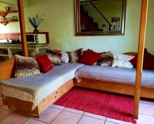 two twin beds in a room with a mirror at Mountain Haven Kaapsehoop in Kaapsehoop