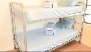 a couple of bunk beds in a room at Peace and Quiet Dorm Rooms - Free Breakfast DIY Waffles - Free Dinner - Free Coffee - Longterm Ok! in Miami
