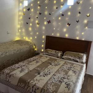 a bedroom with two beds with butterflies on the wall at Casa de campo in Extrema