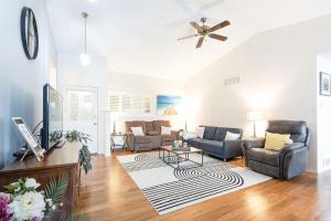 a living room with a couch chairs and a tv at Charming beach home with Ocean & Mt. Baker View in Camano