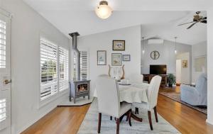 a dining room with a table and chairs and a fireplace at Charming beach home with Ocean & Mt. Baker View in Camano