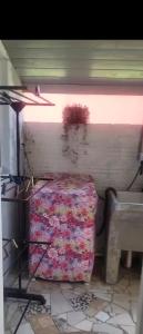 a room with a bed in the corner of a room at Moradas Jane in Paulo Lopes +3 photos