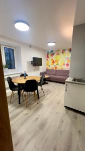 a living room with a table and chairs and a couch at Apartamenty Dąbrówka Cieplice Zdrój 1,15 in Jelenia Góra