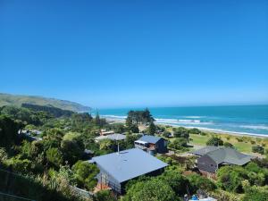 an aerial view of a house and the ocean at Gore Bay View, Tiny Pod, Treehouse in Gore Bay