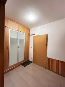 an empty room with two doors and a tile floor at Apartmán Lucie Špindlerův Mlýn in Špindlerův Mlýn