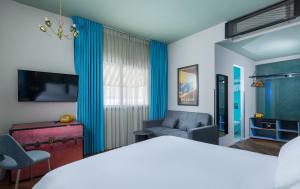 a living room with a couch and a chair at Scarlet Hotel in Tel Aviv