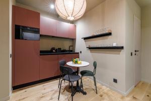 a small kitchen with a small table and chairs at Wonderful Stay close to Garibaldi - Aircon in Nice +5 photos