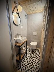 a bathroom with a sink and a toilet at Domki Całoroczne nad Morzem Kraina Bałtyku in Przewłoka