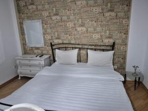 Ένα ή περισσότερα κρεβάτια σε δωμάτιο στο GX Hotel