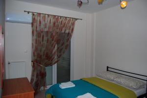 a bedroom with a bed and a window at sofi in Komotini