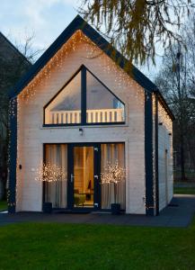 a small house with christmas lights on it at Polna 31 in Olsztyn