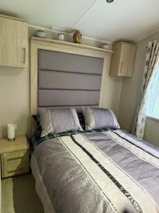 a bedroom with a bed with a large headboard at The Glen Getaway in Dunbar +36 photos