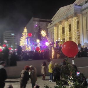 a group of people standing in front of a building with a christmas tree at ATHENS RIVIERA SEA VIEW APARTMENT in Piraeus