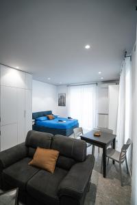 a living room with a couch and a bed at De Luca 6 Apartments - Vinto House Collections in Salerno