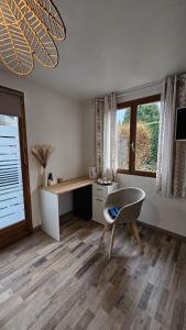 a room with a desk and a table and a chair at Chambre privé climatisé in Vertaizon