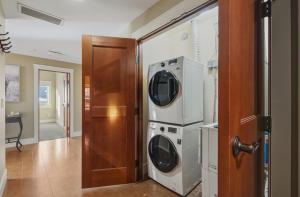 two washers and a dryer in a room at Sunset Ridge - Luxurious Corner Condo - Spectacular Mt Views with open Pool! in Canmore +55 photos