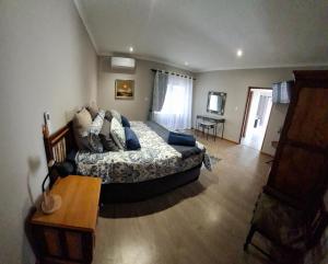 a bedroom with a bed and a table in it at Spacious Suite in Somerset West in Somerset West