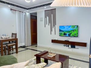 a living room with a couch and a table at Keisha Luxury Furnished Apartment Bukoto in Kampala