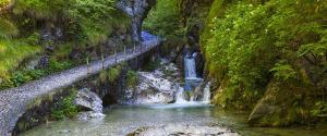 a bridge over a river with a waterfall at Bellavista in Vertova
