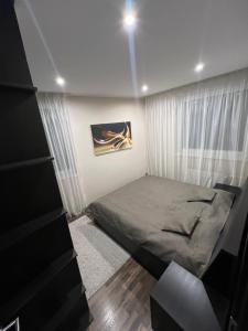 a bedroom with a bed and a window at Šafran Apartment LUX in Donovaly