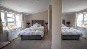 Primrose 1 bed-No Pets-Lily في Horham: سريرين في غرفة ذات نافذتين