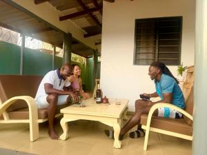 a group of people sitting around a table at Résidence comme à la maison in Lomé