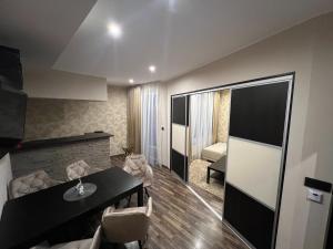 a living room with a black table and chairs at Šafran Apartment LUX in Donovaly