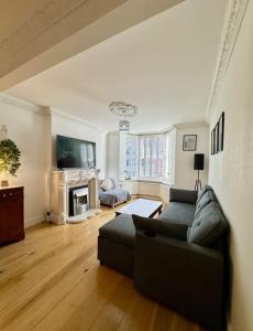 a living room with a couch and a fireplace at Three Bees in Hythe