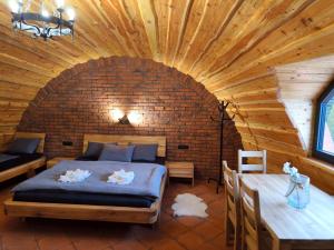 a bedroom with a bed and a table in a room at Liptovský mlyn in Bešeňová