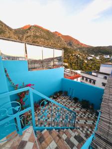 a view from the balcony of a blue house at Authentic Dual Terrace house in Chefchaouene