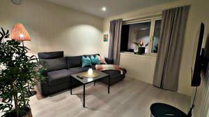 a living room with a couch and a table at Bardufoss Panorama in Bardufoss