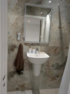 a bathroom with a sink and a mirror at 2 bedroom house with yard in Cardiff