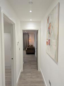 a hallway leading to a room with a couch at 2 bedroom house with yard in Cardiff