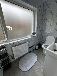a bathroom with a white toilet and a sink at The Forager's Rest in Briton Ferry +70 photos