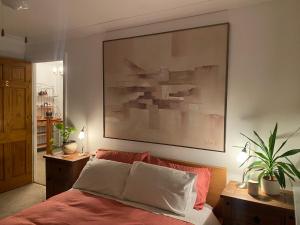 a bedroom with a large painting above a bed at The Forager's Rest in Briton Ferry