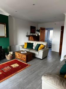 a living room with a couch and a coffee table at The Forager's Rest in Briton Ferry