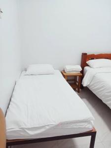 Ένα ή περισσότερα κρεβάτια σε δωμάτιο στο ปุญญพัฒน์ โฮมสเตย์ +4 φωτογραφίες