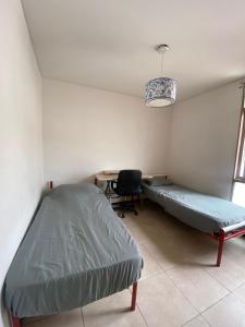 Ένα ή περισσότερα κρεβάτια σε δωμάτιο στο Habitación en Residencia Mendoza Ciudad