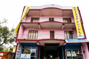 a pink building with a sign on it at SPOT ON Kailash Hotel in Chūharpur