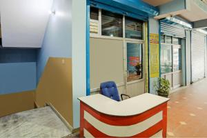 an office with a desk and a blue wall at SPOT ON Kailash Hotel in Chūharpur