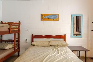 a bedroom with a bed and two bunk beds at Casinhas Terõ - in Boracéia +106 photos