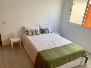 En eller flere senge i et værelse på Fuerteventura Urlaub