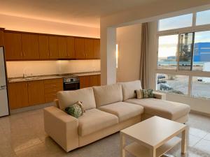 a living room with a couch and a table at Fuerteventura Urlaub in Puerto del Rosario