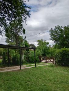 a park with a pavilion and a fence in the grass at Chalet los aromos in Villa Los Aromos