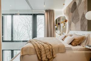 a bedroom with a large bed with a large window at Zegrze Lake Apartament przy Narwi LEKKO z sauną in Zegrze +14 photos
