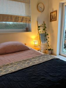 a bedroom with a bed and a window at Art gallery near Pardubice in Mateřov