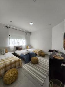 a room with three beds with ottomans at Chácara Segredo in Bonito +17 photos