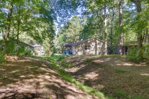an empty yard with a house in the woods at Quiet Ocean Pines Retreat Dogs Welcome! in Ocean Pines